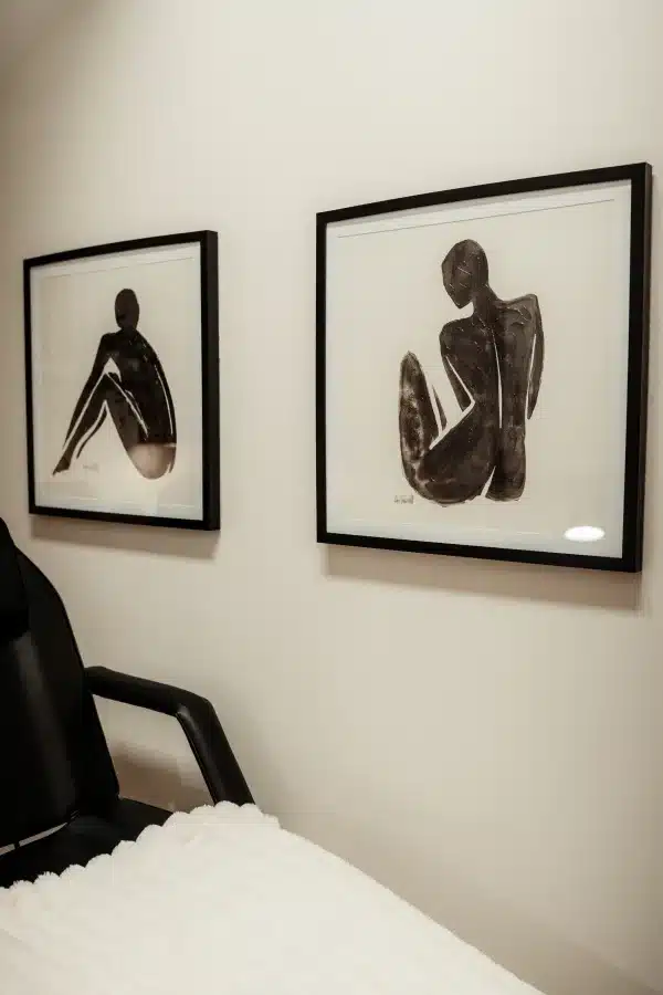 IPL Photofacial in Waunakee, WI 5 Treatment room at Loure Aesthetics with a black leather treatment chair, white blanket and wall art