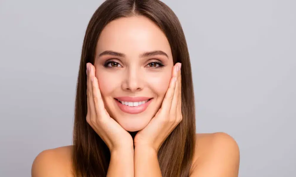 A women showing her glowing face after facial treatment in Waunakee, WI