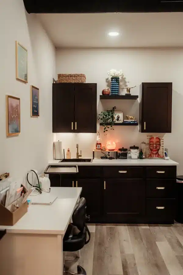 Treatment room cabinetry and sink area at Loure Aesthetics